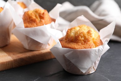 Photo of Tasty muffins on grey table, closeup. Fresh pastry