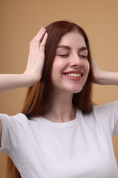 Photo of Portrait of smiling woman on beige background