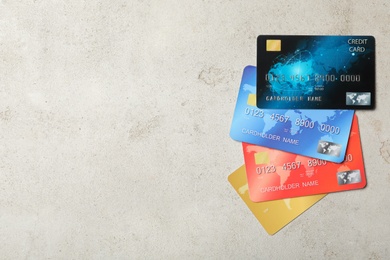Different credit cards on light background, flat lay. Space for text