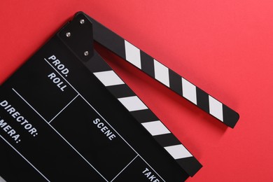 Photo of Clapperboard on red background, top view. Film industry