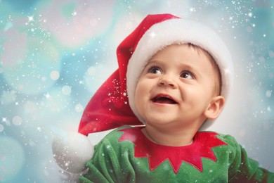 Image of Cute baby in Christmas costume against blurred lights