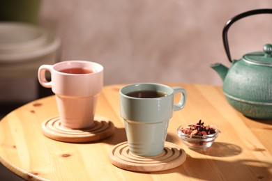 Photo of Aromatic tea, dry flower petals and teapot on wooden table