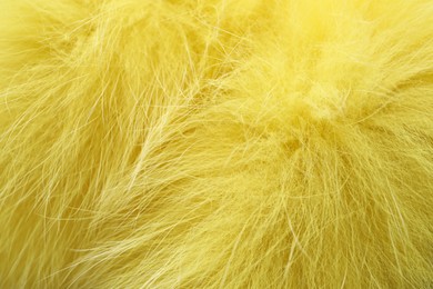 Photo of Texture of yellow faux fur as background, closeup