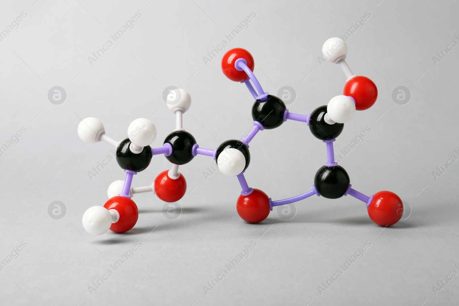 Photo of Molecule of vitamin C on light grey background. Chemical model