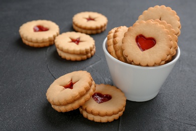 Photo of Traditional Christmas Linzer cookies with sweet jam on table