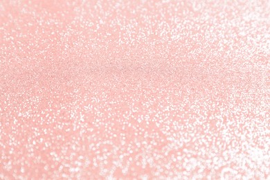 Photo of Beautiful pink shiny glitter as background, top view
