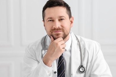 Photo of Portrait of pensive doctor with stethoscope indoors