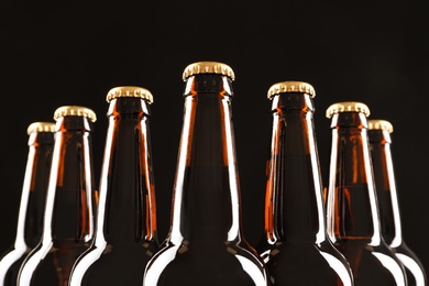 Photo of Many bottles of beer on dark background