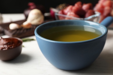 Photo of Pot with hot oil for meat fondue on table, closeup