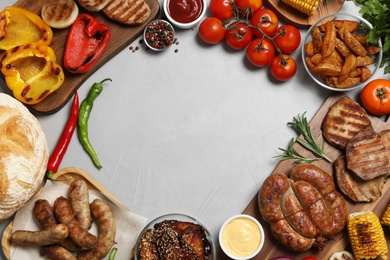 Photo of Frame of barbecued meat and vegetables on light table, flat lay. Space for text