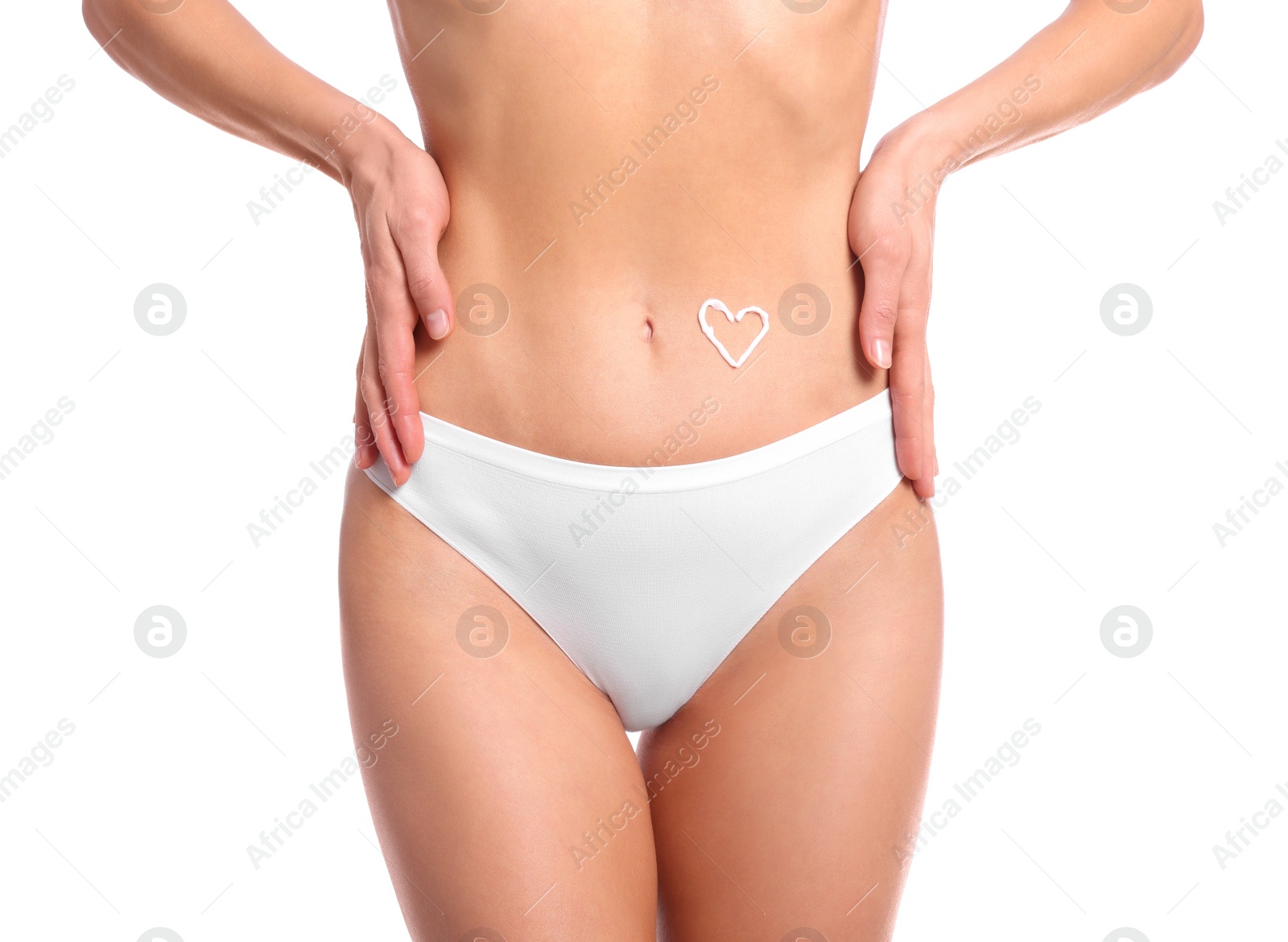 Photo of Woman with body cream onto her belly against white background, closeup