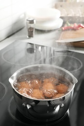 Photo of Cooking chicken eggs in pot on electric stove. Space for text
