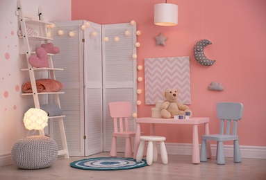 Photo of Modern child room interior with toys and decorations