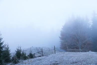 Photo of Beautiful view of countryside with hoarfrost and thick fog