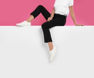 Photo of Woman wearing stylish shoes on color background, closeup