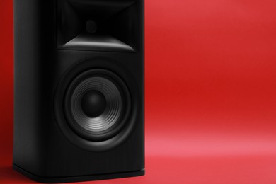 Photo of One wooden sound speaker on red background, closeup. Space for text