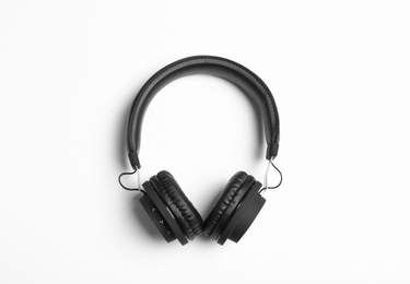 Photo of Stylish modern headphones on white background, top view