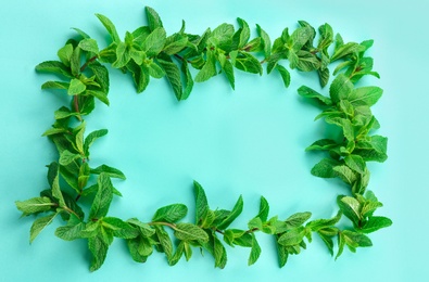 Photo of Frame made of fresh mint leaves on color background, top view
