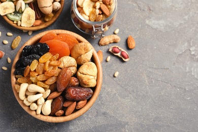 Photo of Flat lay composition of different dried fruits and nuts on color background. Space for text