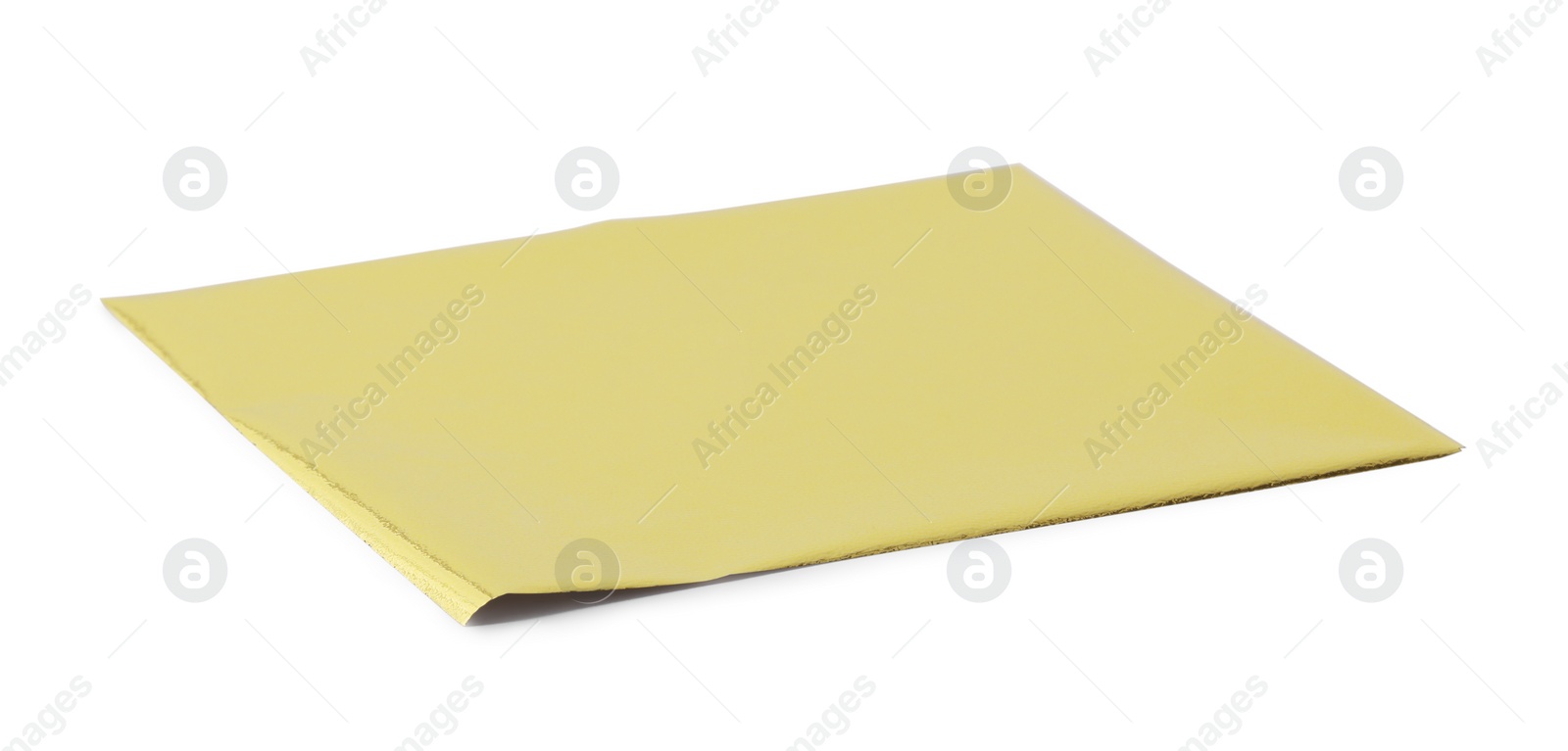 One edible gold leaf sheet isolated on white Photo of One edible gold leaf sheet isolated on white