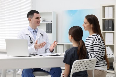 Gastroenterologist consulting woman and her daughter in clinic