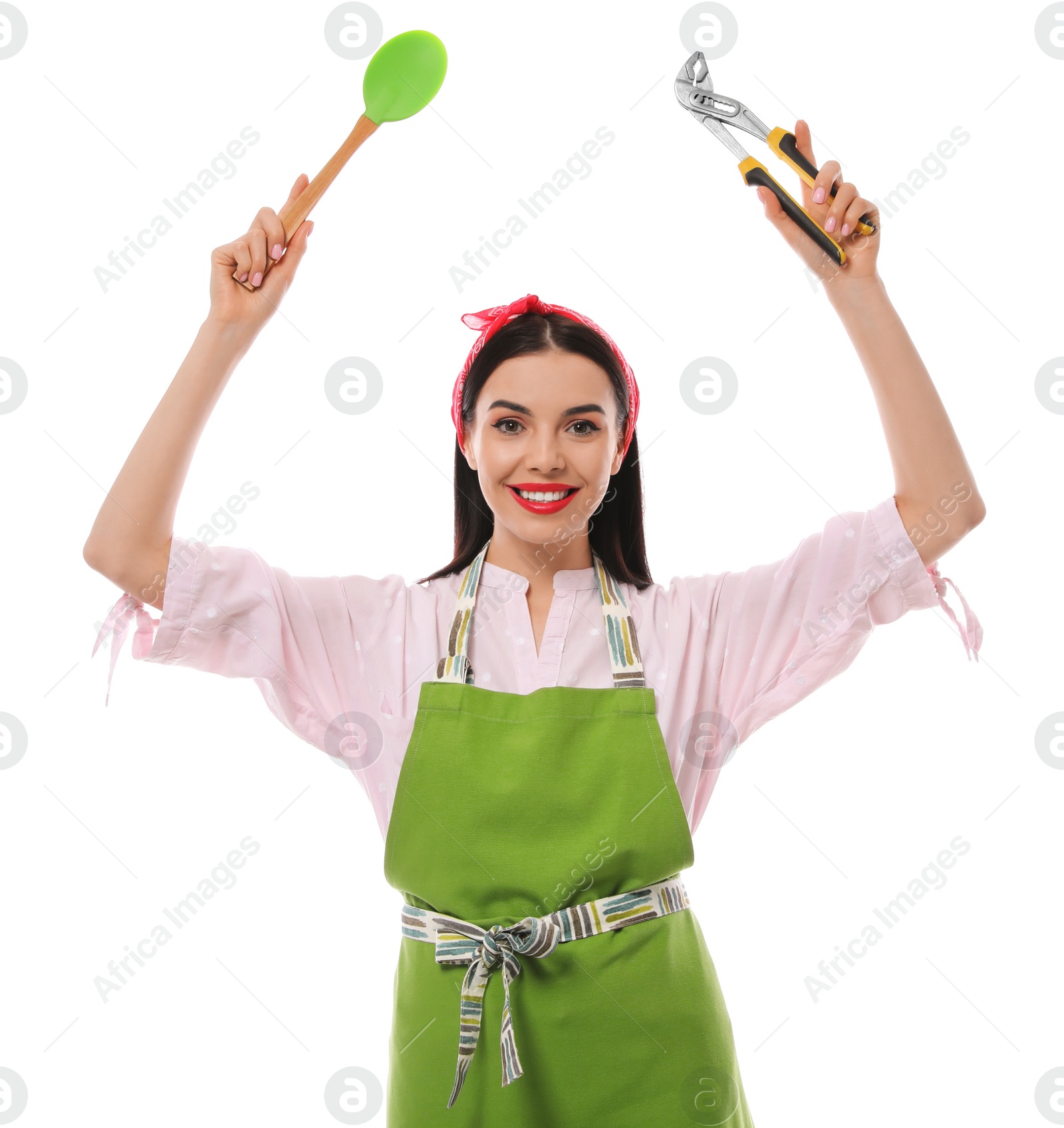 Photo of Young housewife with pliers and spatula on white background