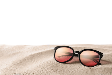 Photo of Stylish sunglasses on sand against white background. Space for text