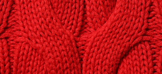 Photo of Texture of soft red knitted fabric as background, top view