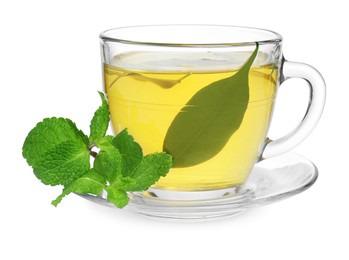 Photo of Fresh green tea in glass cup, mint and saucer isolated on white