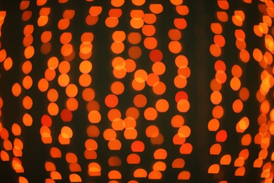 Photo of Beautiful gold lights on dark background. Bokeh effect