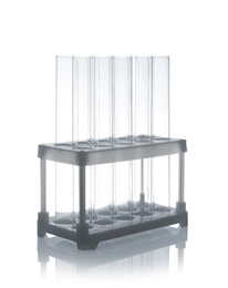 Photo of Empty test tubes in holder on table against white background. Laboratory analysis