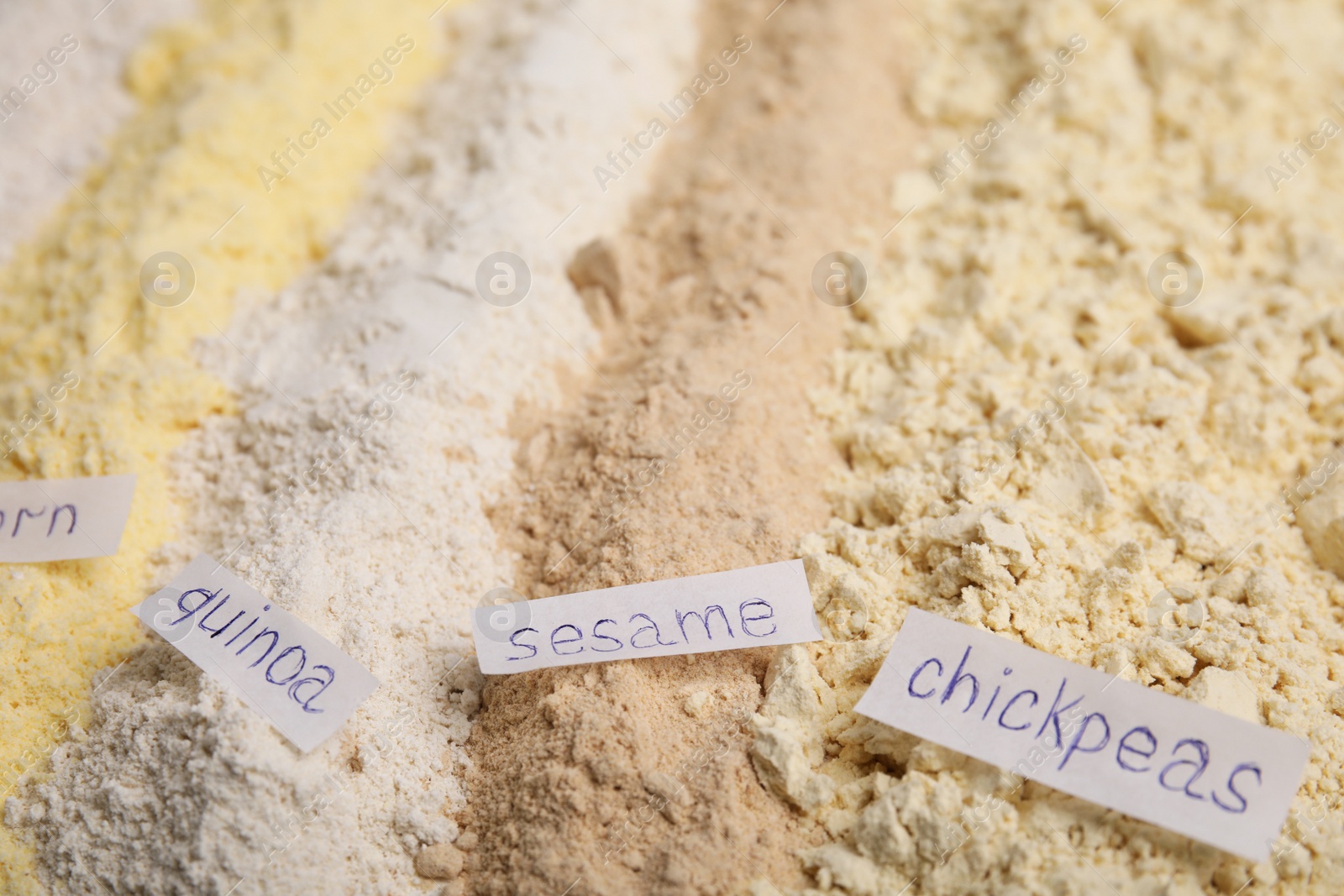 Photo of Different types of flours as background, closeup