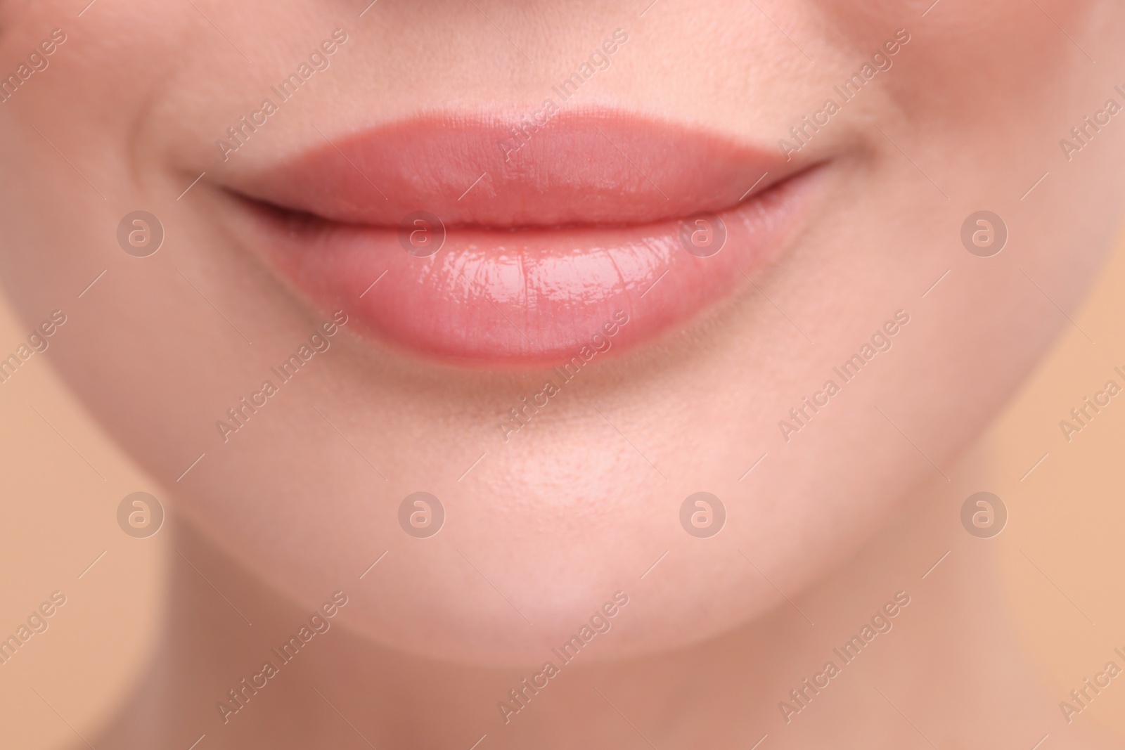 Photo of Woman with beautiful lips on beige background, closeup