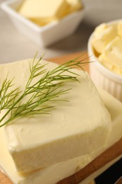 Tasty butter with dill on wooden table, closeup