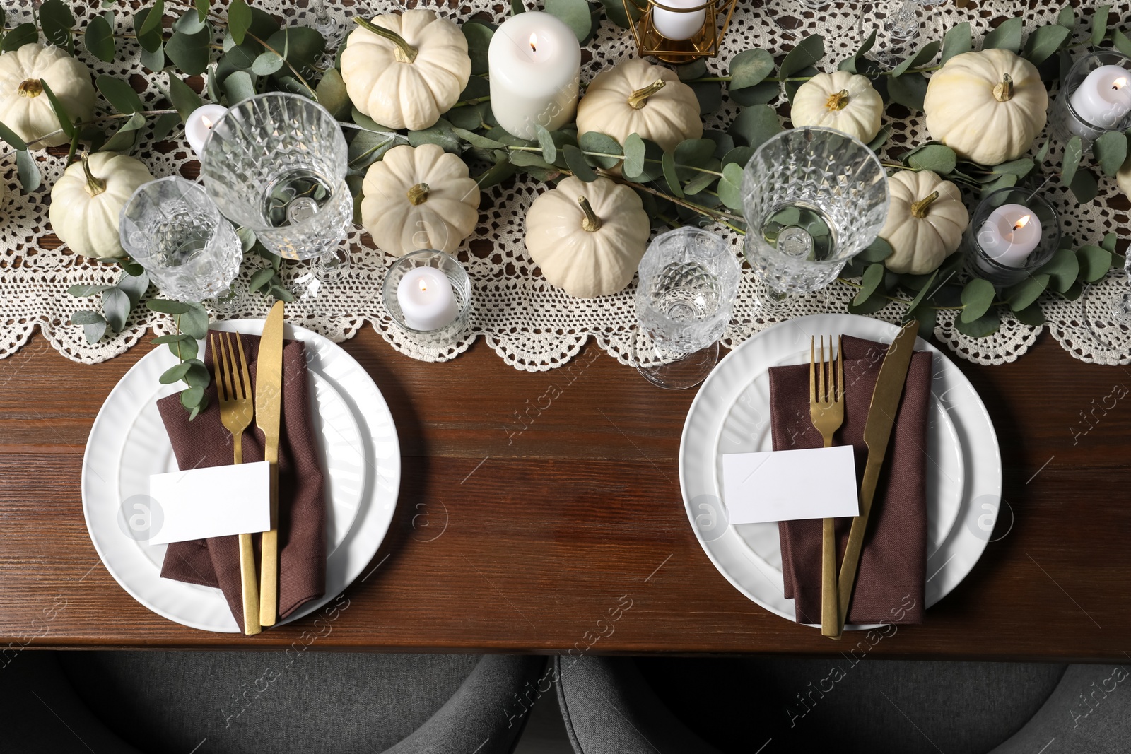 Photo of Beautiful autumn table setting. Plates, cutlery, glasses, blank cards and floral decor, flat lay