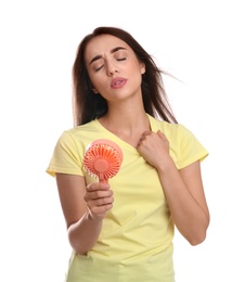 Woman with portable fan suffering from heat on white background. Summer season