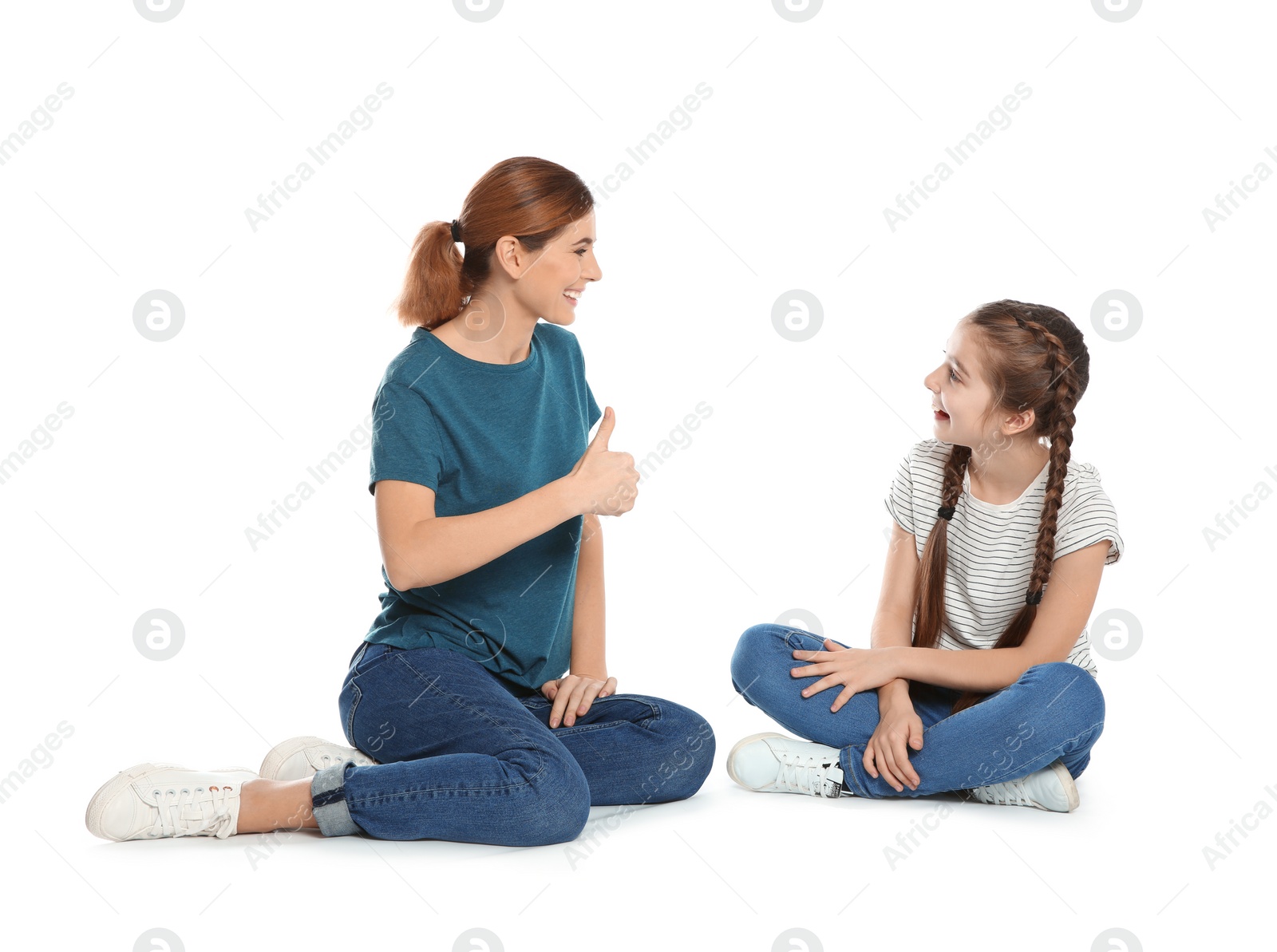 Photo of Hearing impaired mother and her child talking with help of sign language on white background