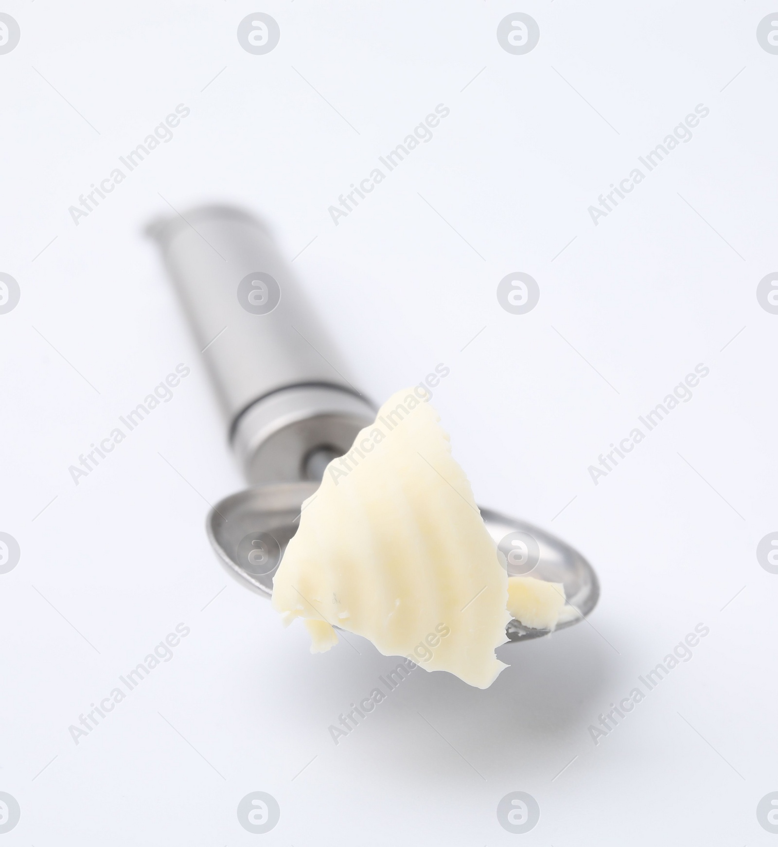 Photo of Butter curl in spoon isolated on white
