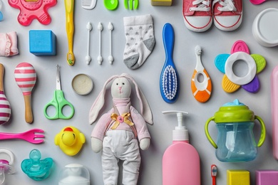 Photo of Flat lay composition with baby accessories and toys on gray background