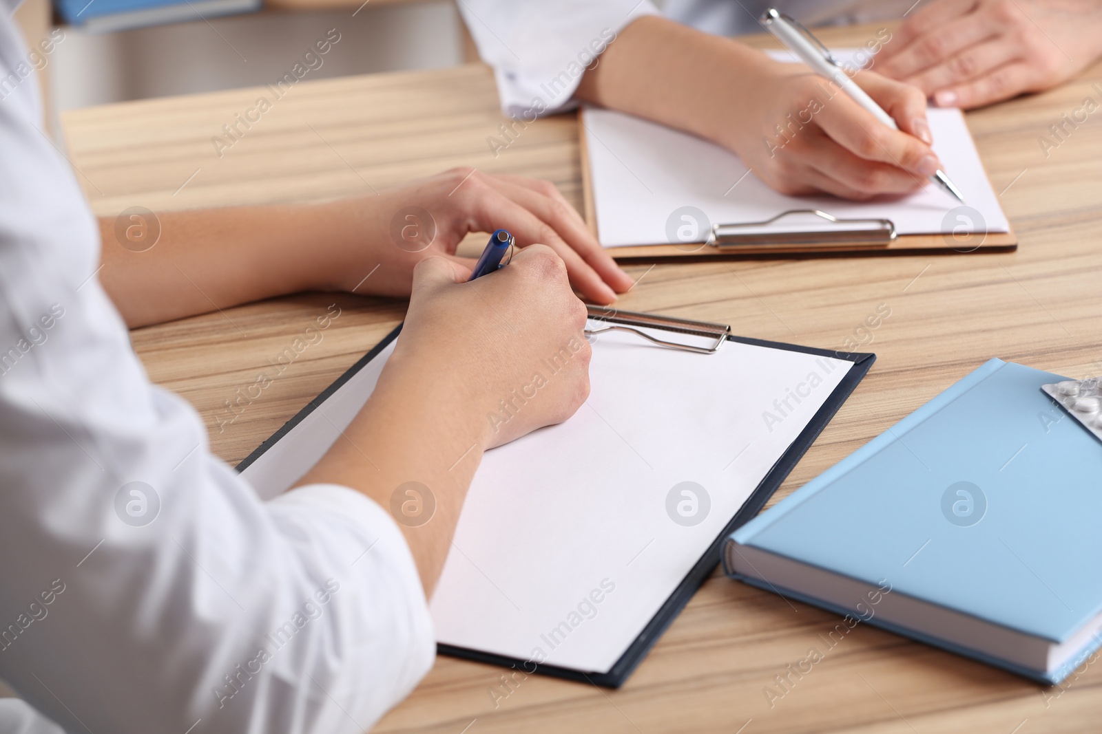 Photo of Doctors working at desk in office, closeup. Medical service