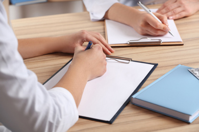 Photo of Doctors working at desk in office, closeup. Medical service