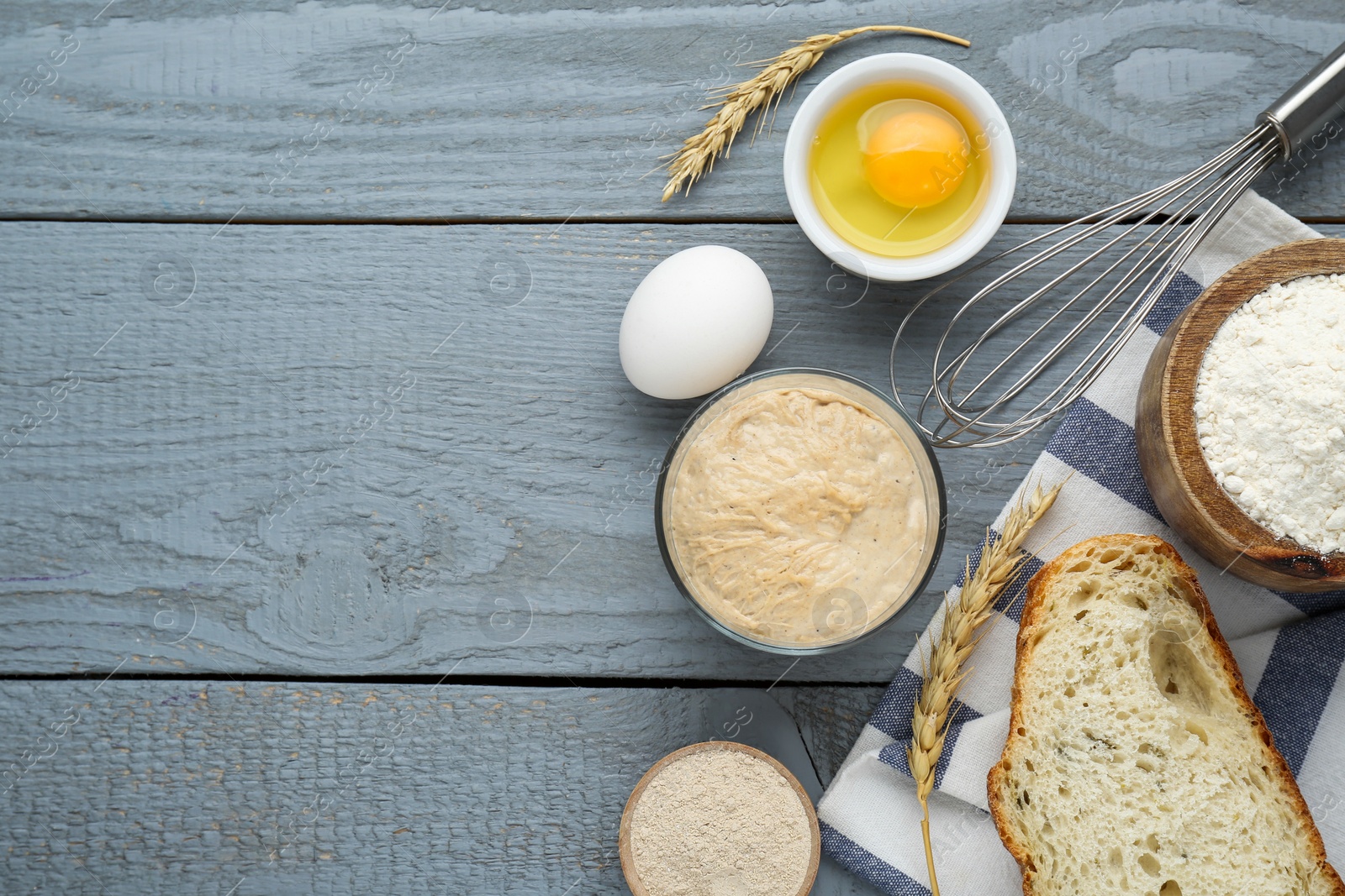 Photo of Flat lay composition with sourdough on grey wooden table. Space for text