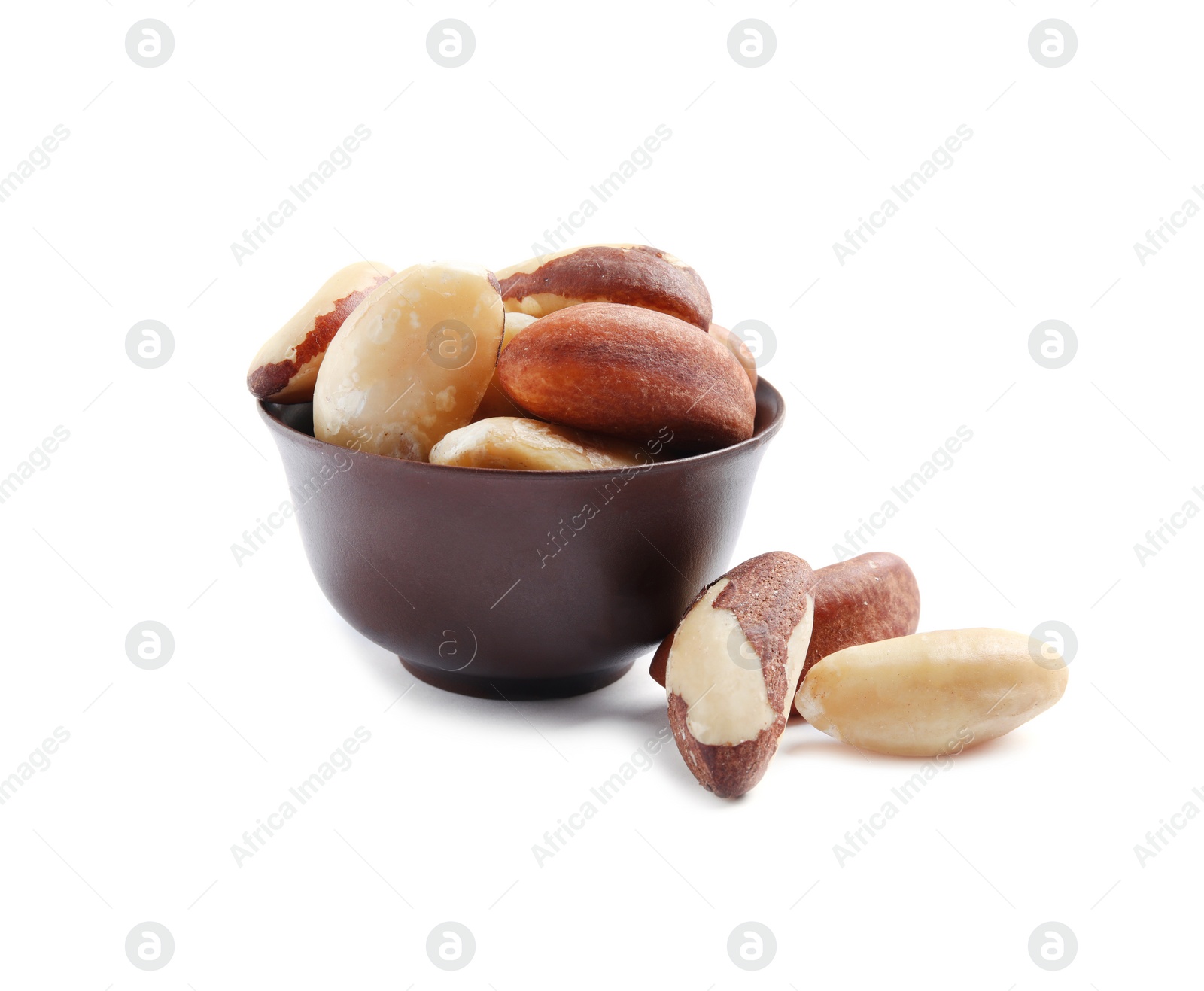 Photo of Bowl with Brazil nuts on white background