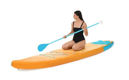 Happy woman with paddle on orange SUP board against white background