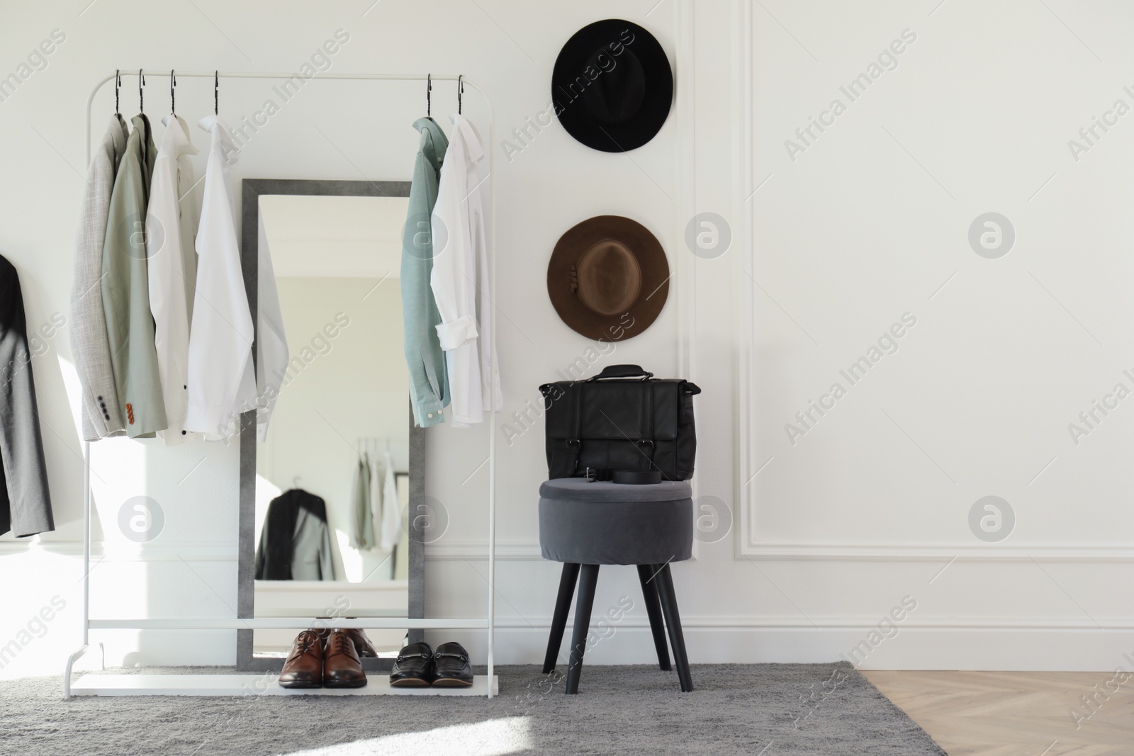 Photo of Rack with stylish clothes in modern dressing room