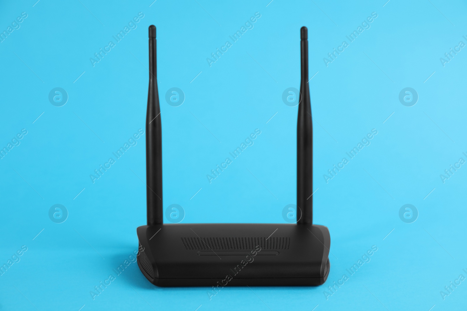 Photo of Modern Wi-Fi router on light blue background