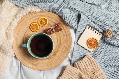 Photo of Flat lay composition with cup of hot winter drink on light fabric