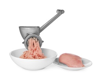 Photo of Metal meat grinder with chicken mince and raw fillet isolated on white
