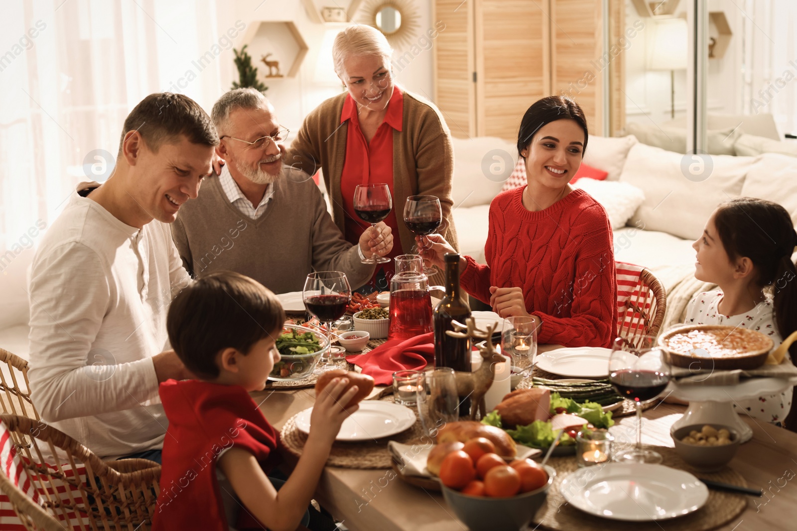 Photo of Happy family enjoying festive dinner at home. Christmas celebration