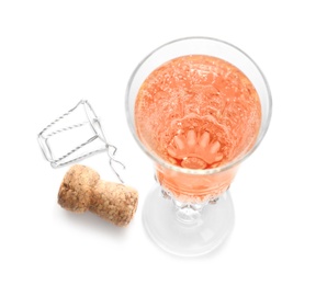 Glass of rose champagne and cork plug on white background